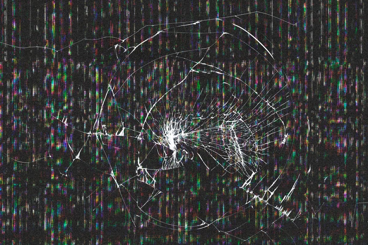 A dark display showing a cracked-glass effect and lines across the panel